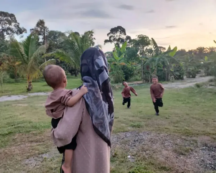 Kanak-kanak berlari di padang rumput